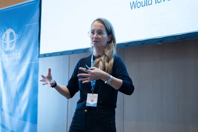 Speaking on stage at Luxatia International